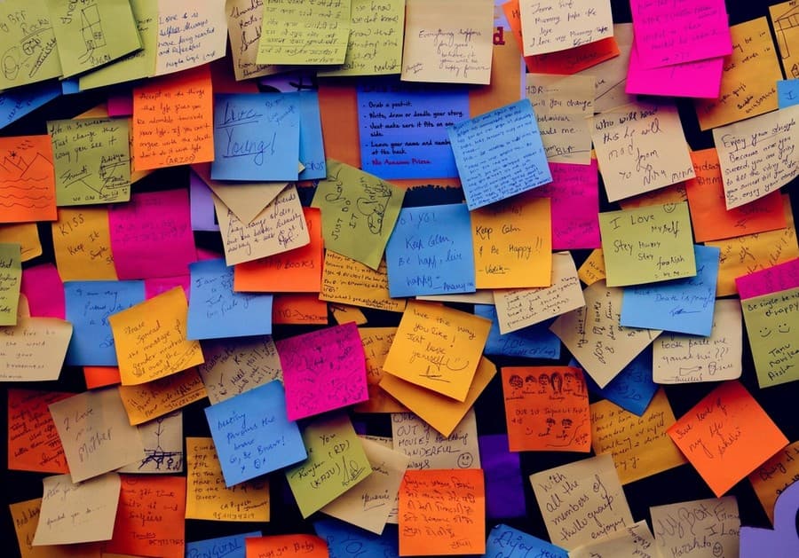 Mur couvert de notes autocollantes griffonnées à la main